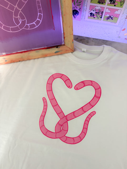 White shirt with pink heart-shaped design on a light background