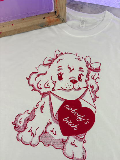 White t-shirt with red graphic of a dog holding a heart and text