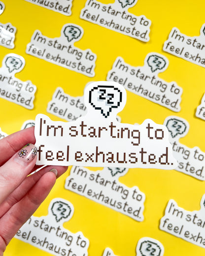 A vinyl sticker with the phrase 'I'm starting to feel exhausted.' printed in a white and grey color scheme, held against a background of the same sticker repeated.
