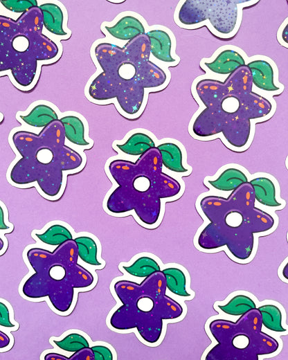 A collection of purple holographic vinyl stickers with a pattern of stars and leaves on a purple background.