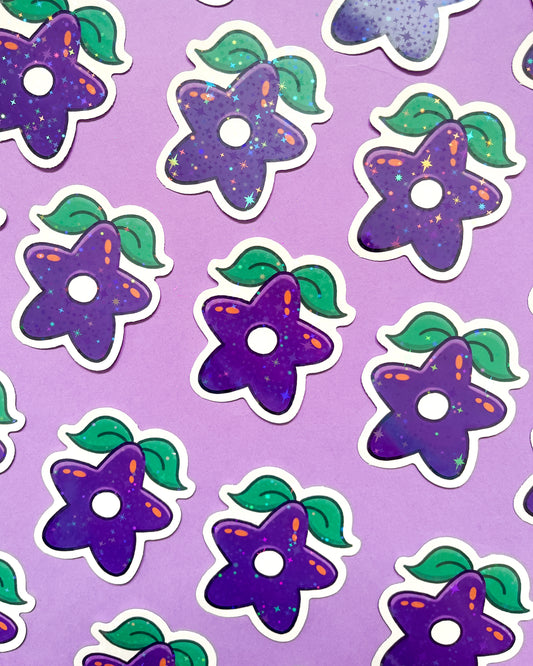 A collection of purple holographic vinyl stickers with a pattern of stars and leaves on a purple background.